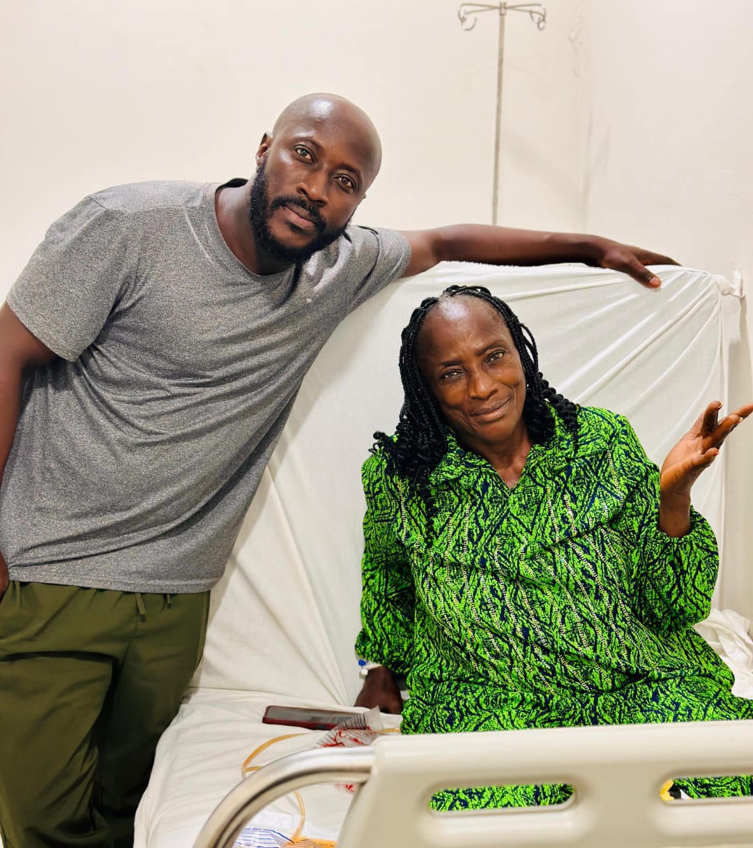 Patient smiling with doctor at bedside